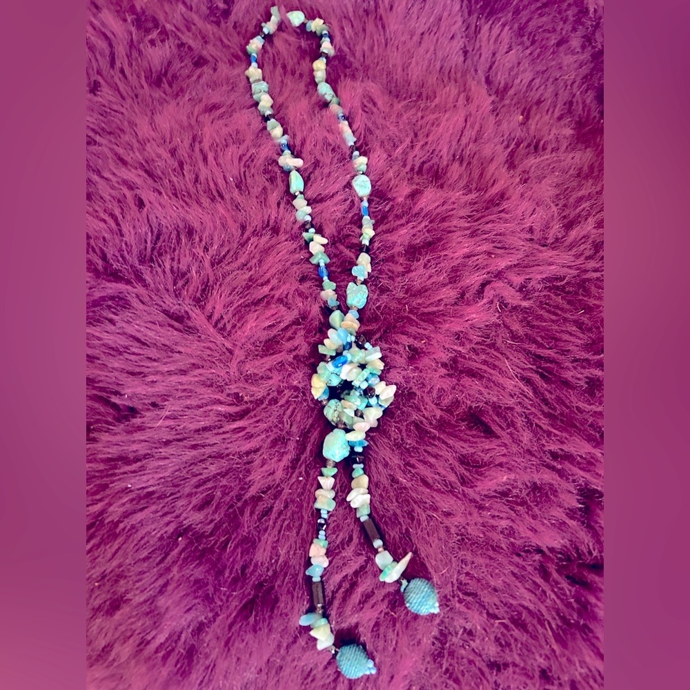 Turquoise color rope necklace.
